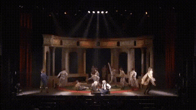 a man in a white robe is walking on stage
