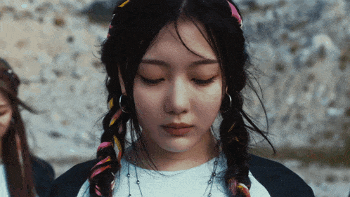 a close up of a woman 's face with braids