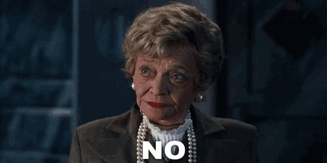 an older woman with pearls and red lipstick says " no "
