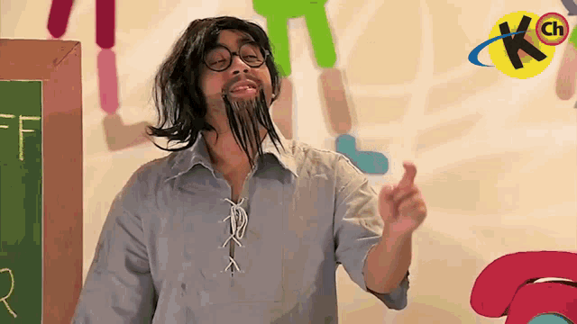 a man with a fake beard and glasses stands in front of a chalkboard with the letter f written on it