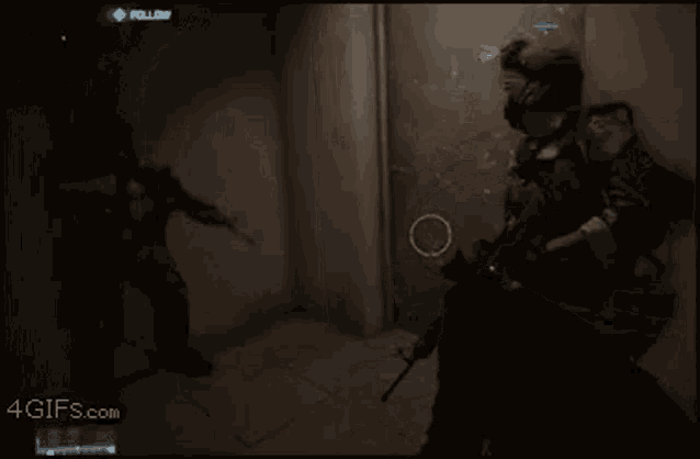 a person holding a gun in front of a door in a video game .