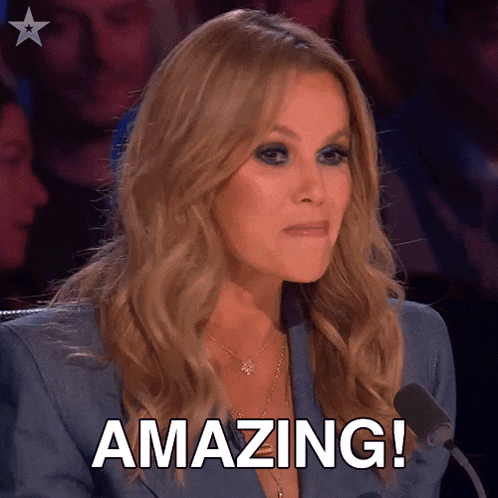 a woman is sitting in front of a microphone and the word amazing is on the screen