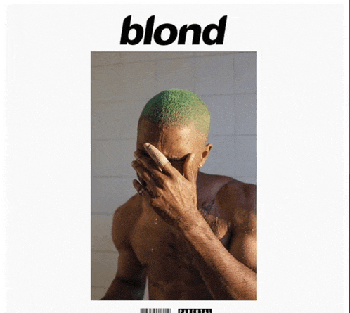 a shirtless man with green hair covers his face on the cover of blond