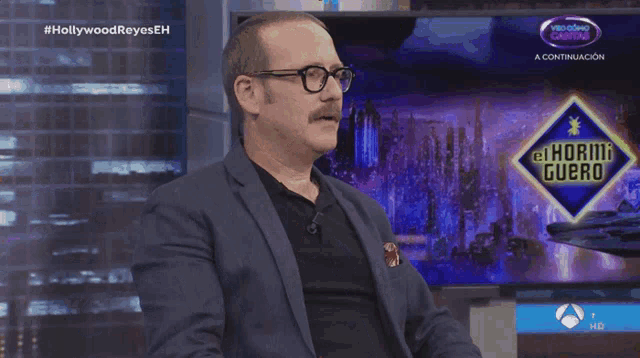 a man with glasses and a mustache is on a tv show called hollywood reyes