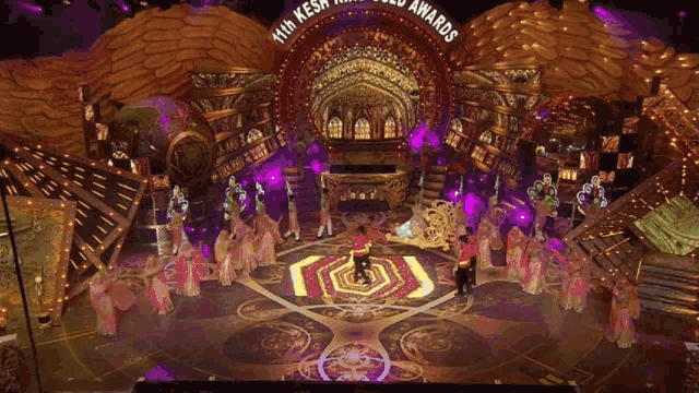 a group of people are dancing in front of a stage that says 11th kesh awards