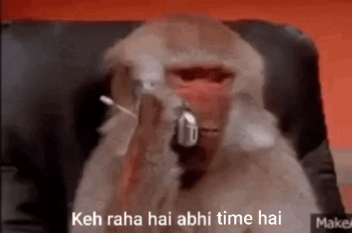 a monkey is sitting in a chair smoking a cigarette and talking on a cell phone .