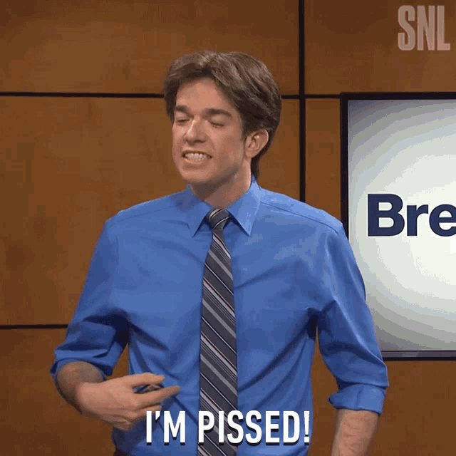 a man in a blue shirt and tie is saying " i 'm pissed "