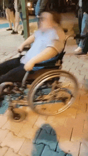 a man in a wheelchair is being pushed by another man