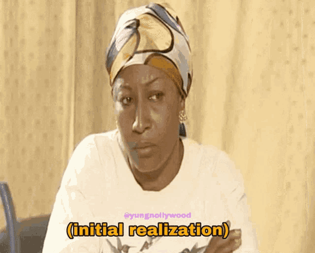a woman wearing a head scarf and a white shirt says further realization