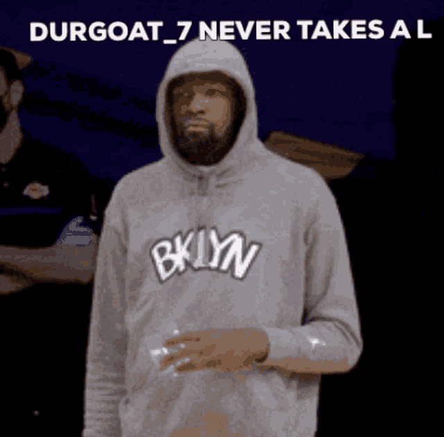 a man wearing a hoodie that says bklyn on it