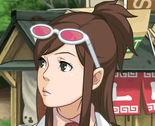 a girl wearing sunglasses is standing in front of a sign that says l