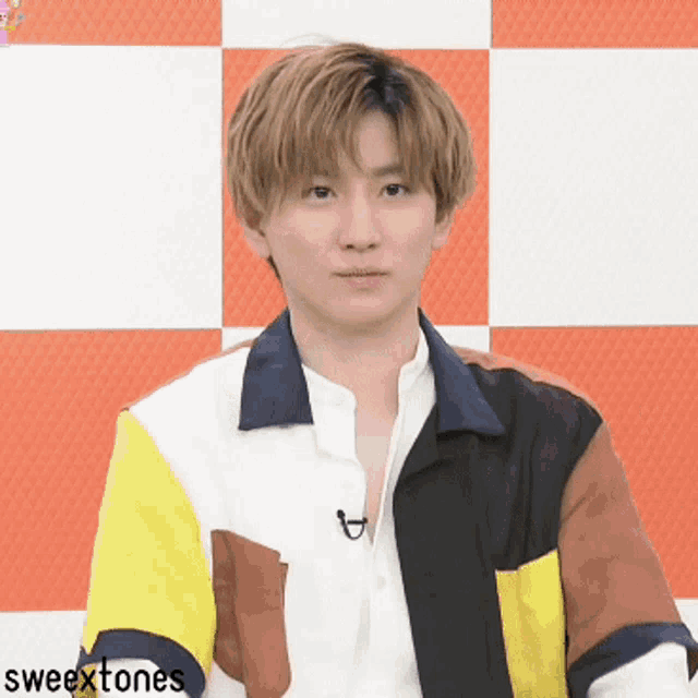 a man wearing a colorful shirt with the words sweettones on the bottom right