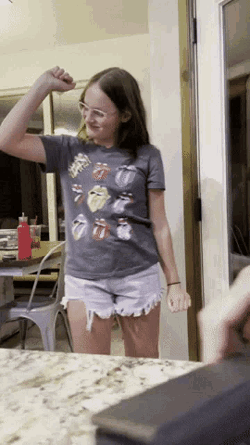 a young girl wearing a rolling stones shirt