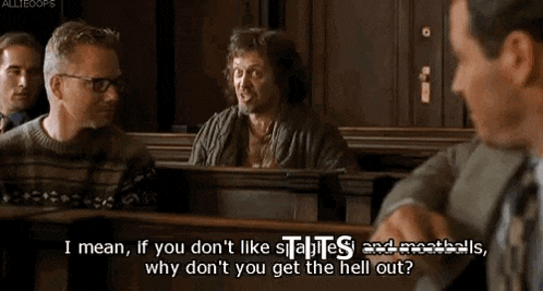 a group of men are sitting in a courtroom and one of them is talking to another man .