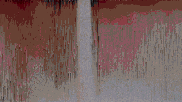 a white wall with red lines and a black letter x