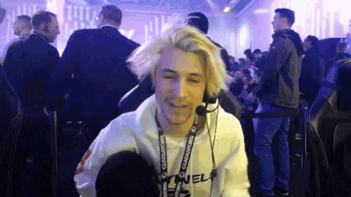 a man wearing headphones and a lanyard that says camel on it