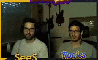 two men are sitting in front of a screen that says see 's rooles
