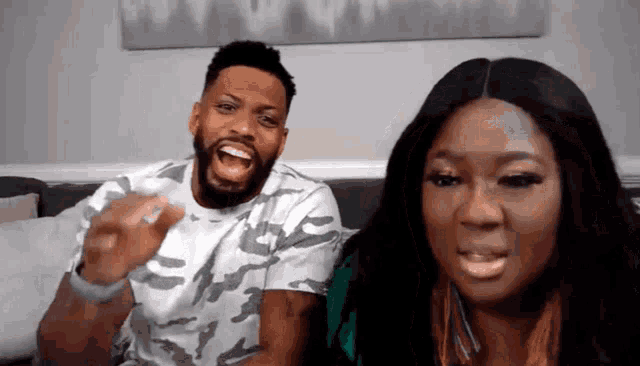 a man and a woman are sitting on a couch .
