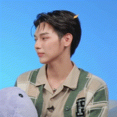 a young man is holding a stuffed animal in his hands .