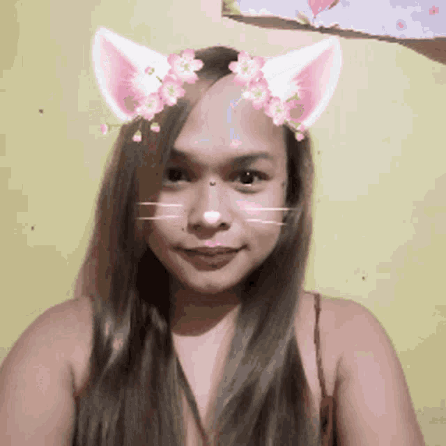a woman wearing a cat mask with flowers on her face