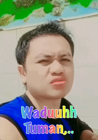a man wearing a blue shirt with the words waduhh tuman