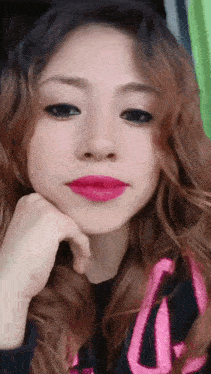 a close up of a woman 's face with a pink lip