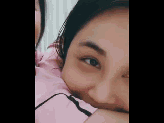 a close up of a woman 's face with her hand on her face