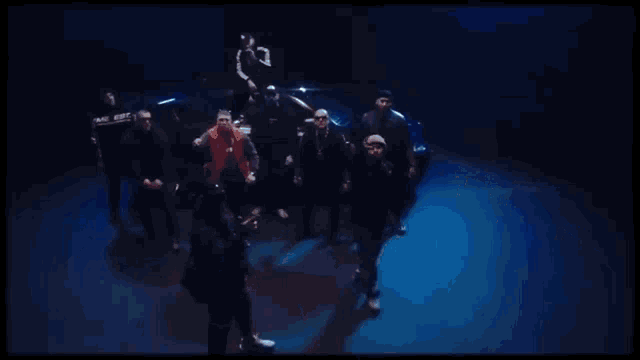 a group of men are standing in a dark room holding guns