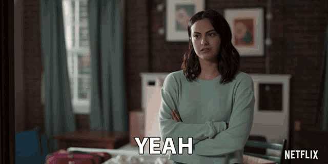 a woman with her arms crossed says " yeah "