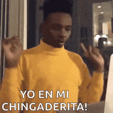 a man in a yellow turtleneck sweater is making a funny face and saying yo en mi chingadera .
