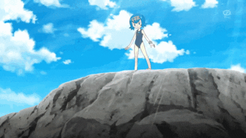 a girl in a bathing suit is standing on top of a rocky cliff
