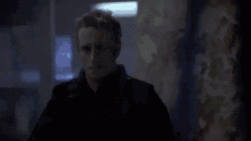 a man and a woman are standing in a dark room in a dark room .