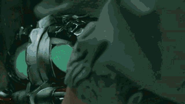 a close up of a person holding a device with green lights