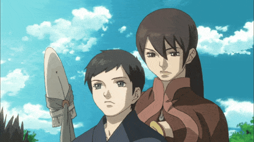 a man and a woman are standing next to each other with a blue sky in the background