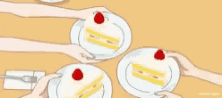 a group of people are sitting at a table holding plates of cake with strawberries on them .