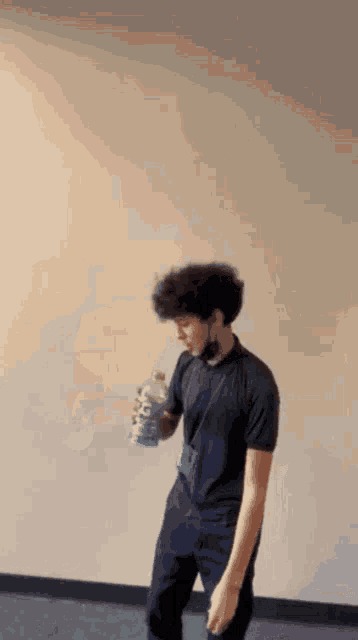 a man is holding a bottle of gatorade in his hand