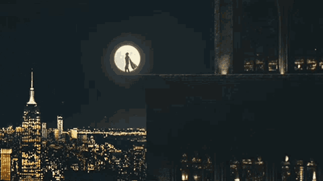 a man is walking on a bridge overlooking a city at night
