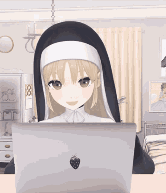 a nun is sitting at a desk with a laptop