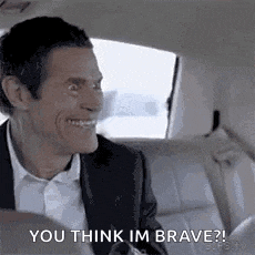 a man in a suit and tie is sitting in the back seat of a car .