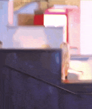 a blurred image of a person standing in front of a staircase