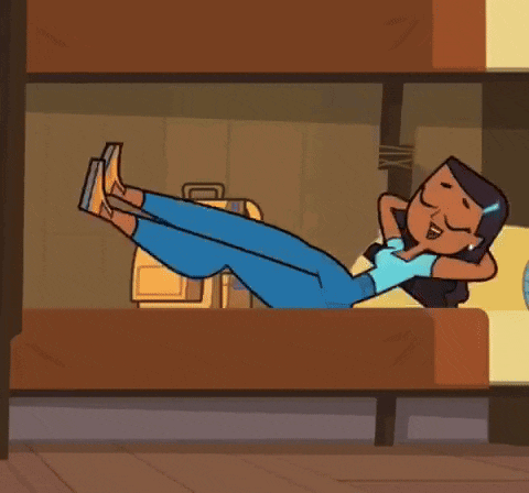 a girl is laying in a bunk bed with a suitcase .