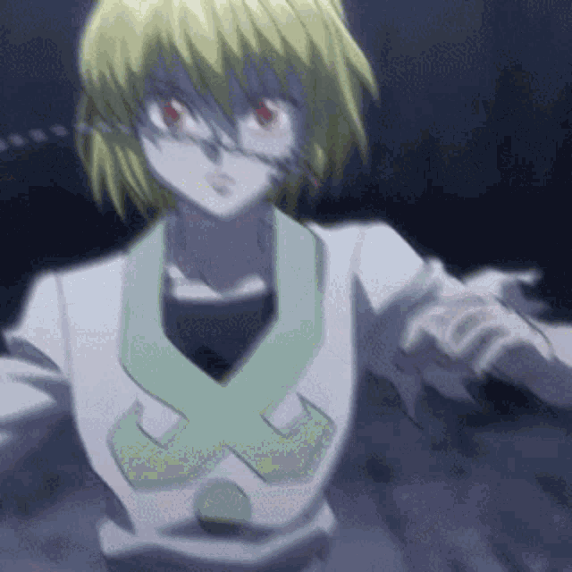 a girl with blonde hair and red eyes is wearing a white shirt with a green x on the collar .
