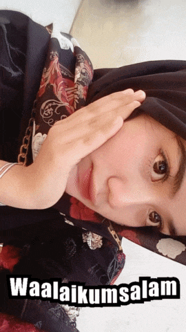 a woman wearing a hijab is covering her face with her hands and the words waalaikumsalam written below her