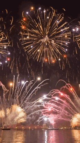 a fireworks display over a body of water at night