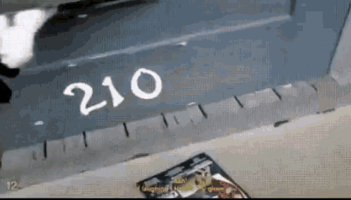 the number 210 is written on a wall next to a magazine
