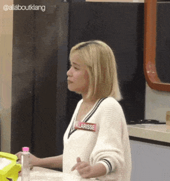 a blonde woman with a name tag that says klarisse on it