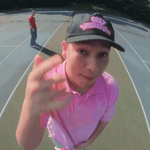 a man wearing a hat that says obey world cup