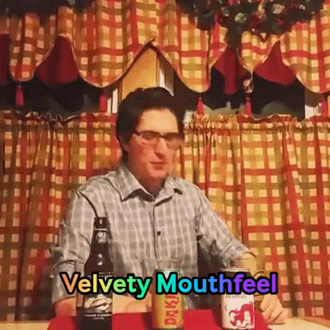 a man sitting at a table with velvety mouthfeel written on the bottom of the image