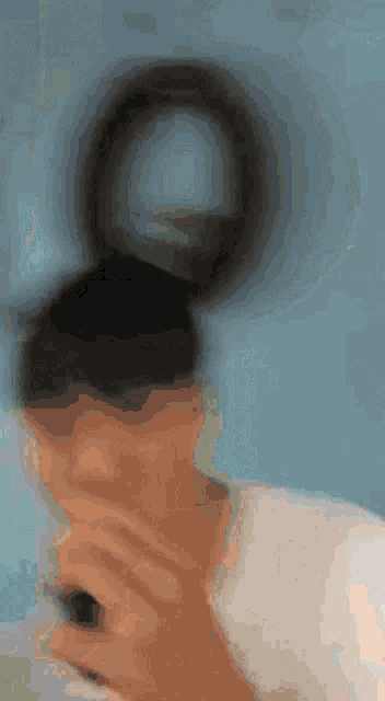 a blurry picture of a person looking at a phone