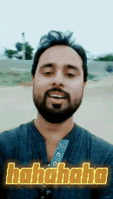 a man with a beard is making a funny face with the word hahahaha written in yellow letters